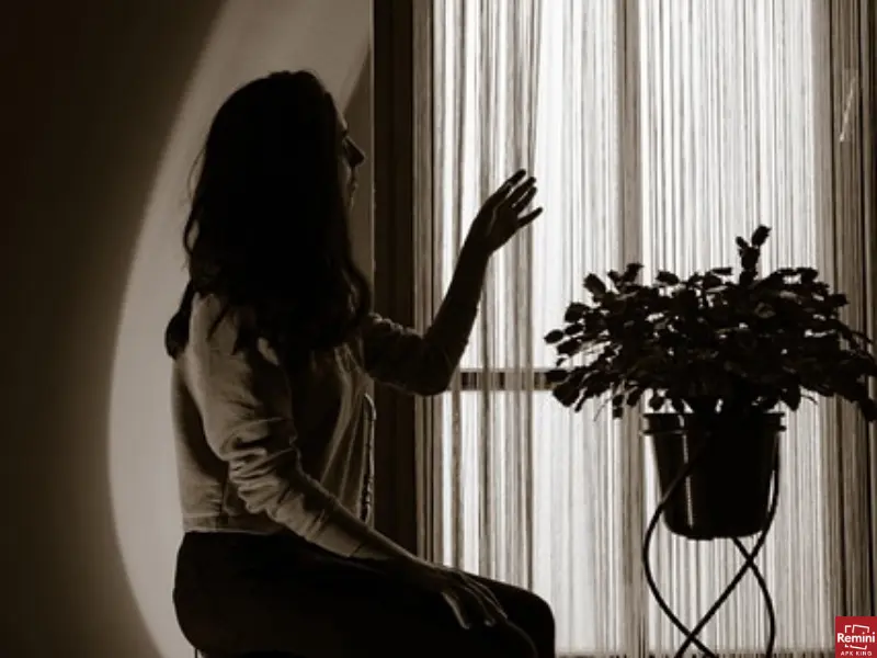 How To Take Dark & Moody Photos 7 Girl siting near window in dark photography
