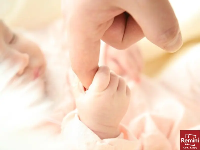 Photographing Your Baby's Milestones – A First Year Photoshoot 8 sleeping baby with finger holding
